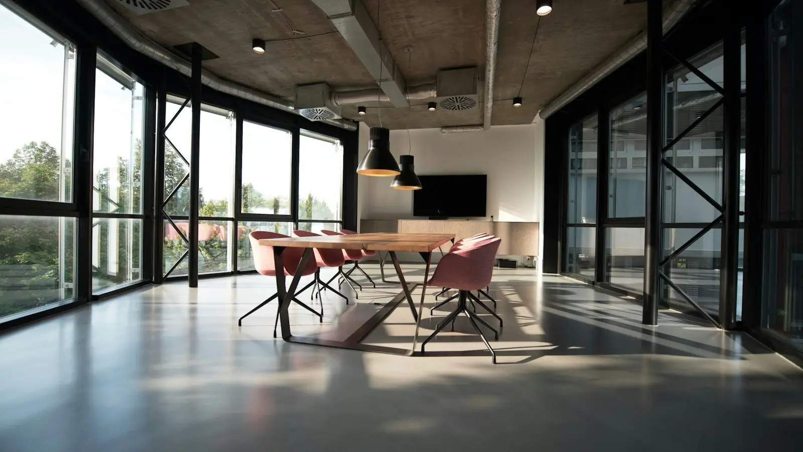 Bright office with glass walls and a clean meeting table